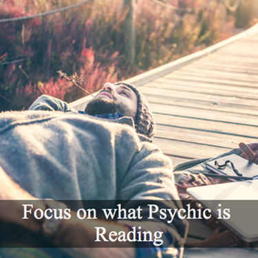 Man laying down on bridge looking up on sky with words Focus on what psychic is reading